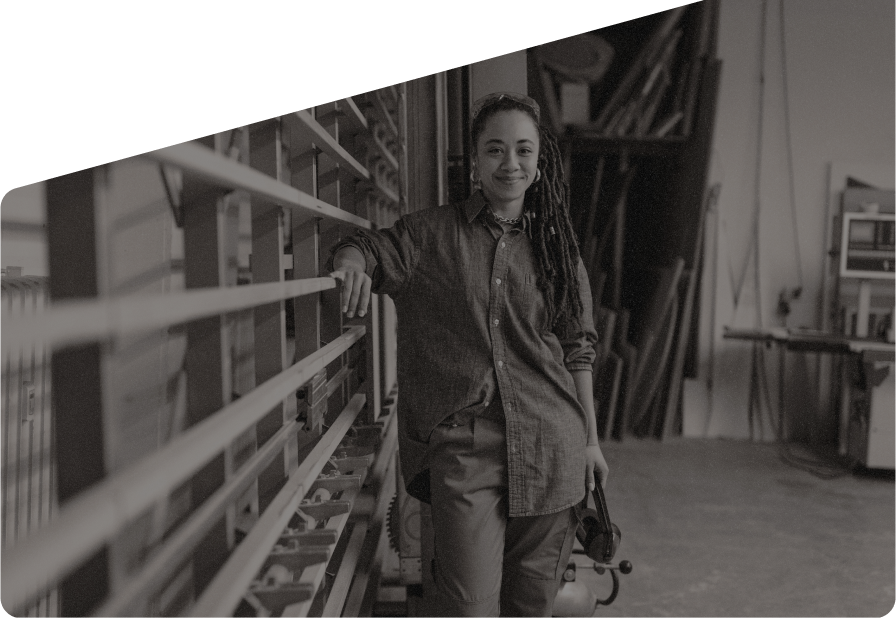 Student standing in a workshop at a high school