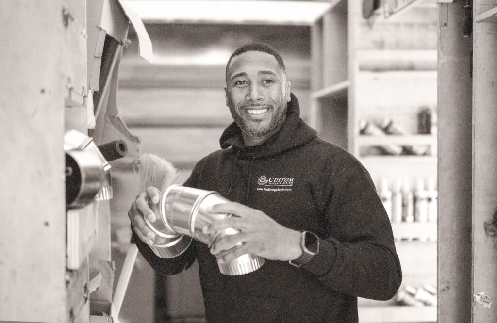 Weatherization worker holding pipe