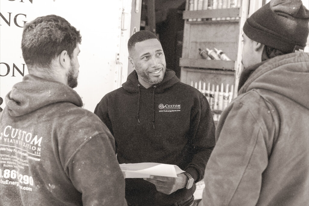 Weatherization worker speaking to his crew