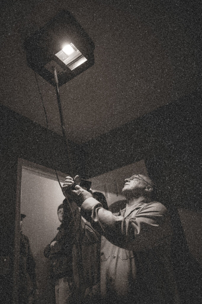 Weatherization workers testing a ceiling vent for air leakage